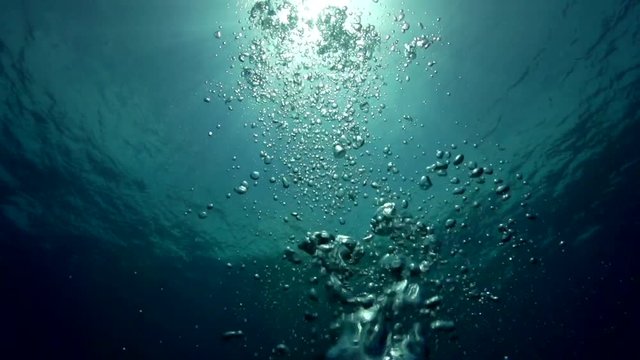 Bubbles float in ocean, POV