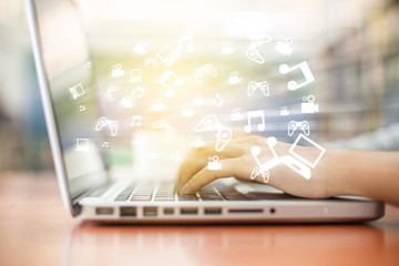 laptop emitting holographic image of social media related icons