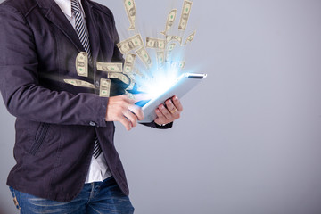 business man using a laptop building online business making money dollar bills