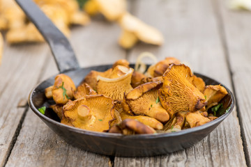 Fresh made Fried Chanterelles on a rustic background