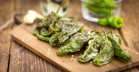 Fresh made Pimientos de Padron on a rustic background