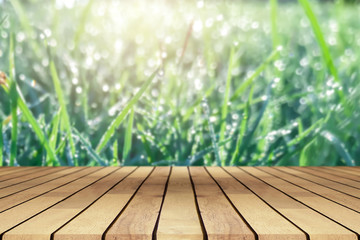 Perspective wooden table on top over blur natural background, can be used mock up for montage products display or design layout.