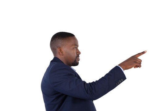 Businessman pressing an invisible virtual screen