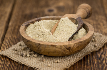 Portion of White Pepper on wooden background, selective focus