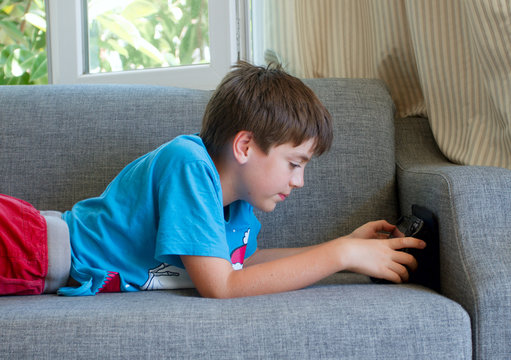 Teenager styding with a tablet at home/Teenager boy styding and playing with a tablet at home