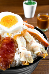 Barbecued red pork in sauce with rice, the distance look delicious. Foods placed on the dining table and look beautiful.