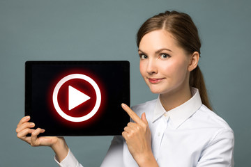 Young woman showing movie play button.