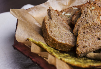Different types of fresh bread on the bakery paper. Close up