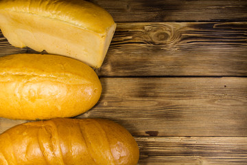 Assortment of baked bread on wooden table