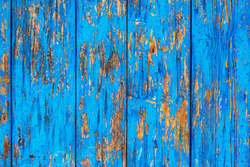 Fototapeta na wymiar Blue weather worn wooden texture with paint peeling off