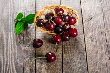 Cherry on a wooden table in a wicker