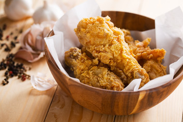 fried chicken in wooden bowl with garlic and pepper ingredient