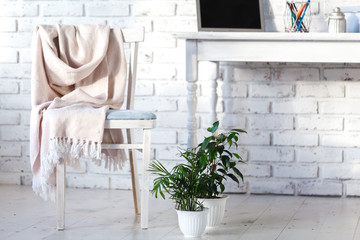 White interior with chair, rug and small table