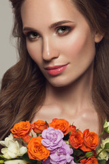 Fototapeta na wymiar Close up portrait of young beautiful woman with flowers.