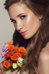 Close up portrait of young beautiful woman with flowers.