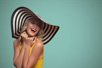 Pop art portrait of beautiful woman in hat. Blue background.