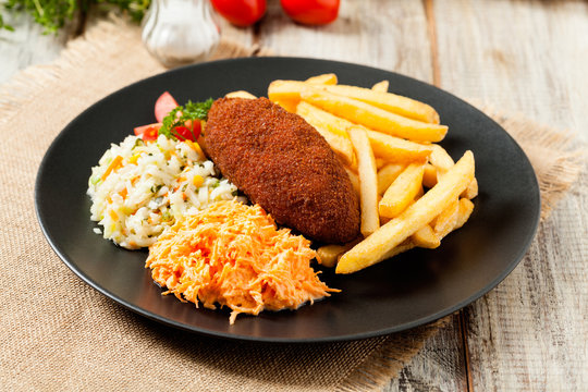 Chicken Kiev (de Volaille chop) with french fries and salads.
