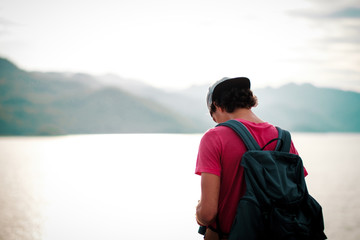 Fototapeta premium Man traveler traveling walking with backpack at the jungle on holiday at weekend on background nature view