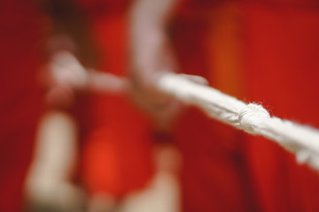 Monk Hand holding big rope for leading people and dead body carrying car to crematory or graveyard...
