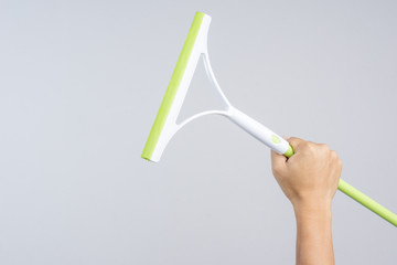 Hand holding window cleaning tool,glass wiper or wet floor cleaner, rubber with plastic handle