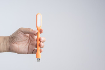 Hand holding plastic USB LED portable lamp