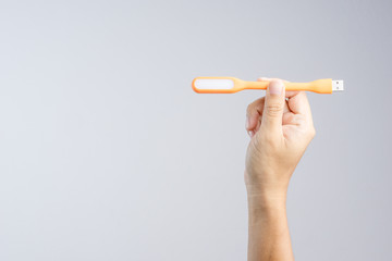 Hand holding plastic USB LED portable lamp