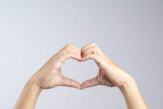 Hand making a heart shape, love and relationship gesture concept