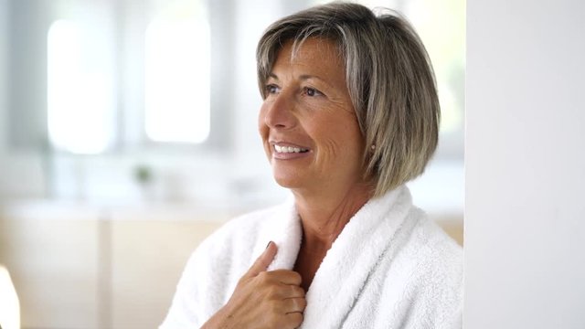 Portrait of smiling senior woman in bathrobe