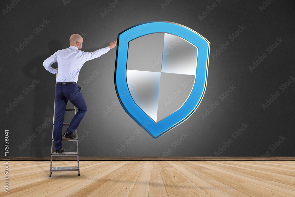 Aufkleber businessman in front of a wall with a shield symbol displayed on a futuristic interface - technology