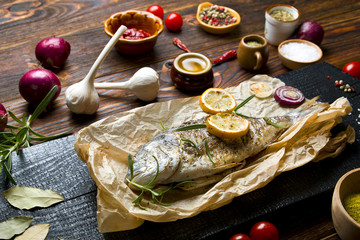 Delicious grilled fish on a wooden background