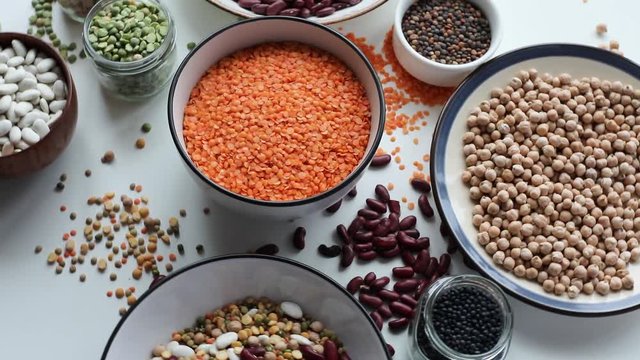 Various dry legumes on a wooden background. Top view