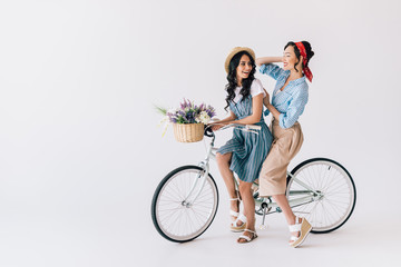 multicultural women on bicycle