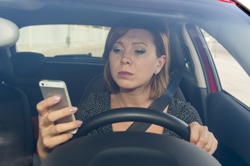 worried and stressed woman driving car while texting on mobile phone distracted