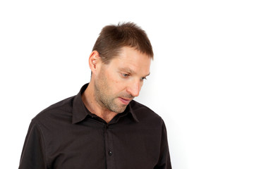 Fototapeta premium A young man looking down in disappointment