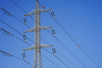 High voltage electric poles on blue sky background   