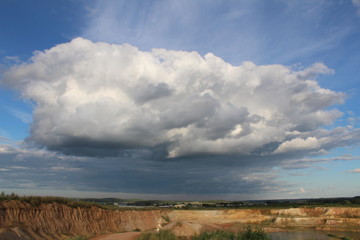 big cloud in the blue sky above the quarry