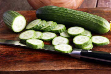 Fresh and sliced cucumbers. Sliced cucumbers on a cutting board. cucumbers for diet and healthy eating