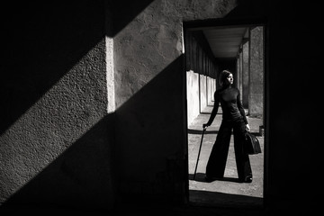 Fashion art portrait of elegant girl in geometric. Black and white photo of stylish young woman in cityscape