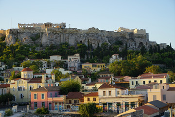 Fototapeta na wymiar View of the ancient Acropolis, Erechtheion, from Monasteraki Square through old town neighborhood buildings