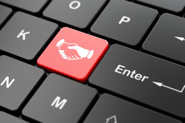 Business concept: Handshake on computer keyboard background