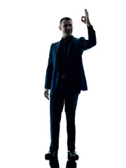 one caucasian business man standing okay sign  silhouette isolated on white background