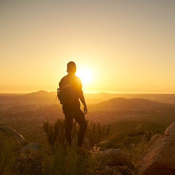 Young Bearded Millennial Man Hiking On Top Of Hill In California Over Looking San Diego At Sunset