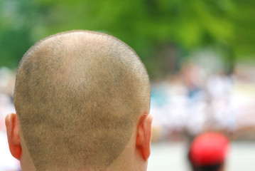 shot from behide of asia buddhist monk shaved head at outdoor