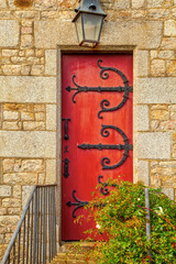 old stone doorway with red wooden door