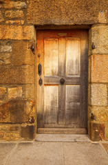 Old stone doorway with weathered door