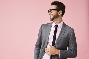 Laughing guy in business suit, looking away