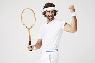Cheering tennis dude with racket, portrait