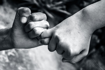 A hand helping another hand to come out of fear.