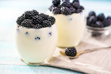 Fototapeta na wymiar Two bowl of blackberry yogurt on wooden background,Selective focus