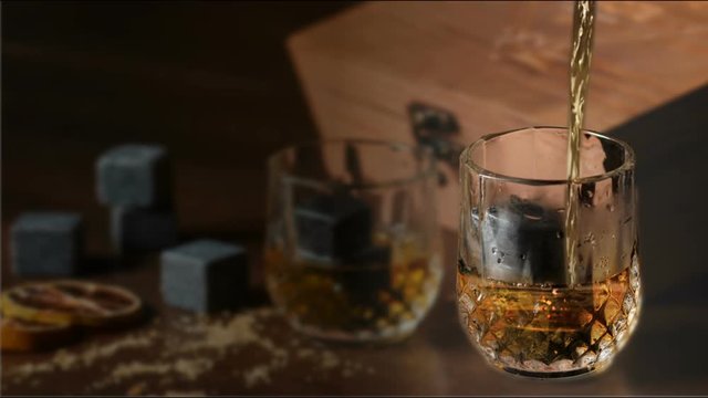 Pouring A Scotch Whiskey To Glass On The Rocks